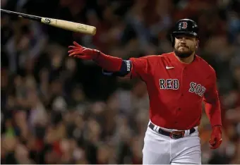  ?? MATT STONE / HERALD STAff ?? WHO’S ON FIRST? Kyle Schwarber flips his bat after launching a grand slam during the second inning on Monday night at Fenway Park.