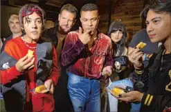  ?? Jay L. Clendenin Los Angeles Times ?? CASTMATES Tyroe Muhafidin, left, Lloyd Owen, Ismael Cruz Cordova, Markella Kavenagh and Muhafidin’s brother, Tobias, snack on Twinkies backstage at a fan event during Comic-Con Internatio­nal 2022 at the San Diego Convention Center.