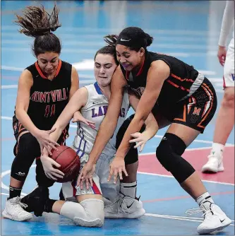  ?? SARAH GORDON/THE DAY ?? Montville’s Lauren Velazquez, left, and Maya Hillman, right, fight for a loose ball with Waterford’s Gaby Kramer during Wednesday’s girls’ basketball game at Waterford. Go to www.theday.com to see a photo gallery of Wednesday’s game.