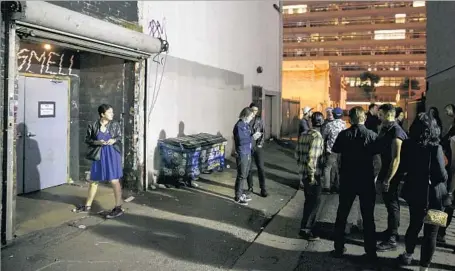  ?? Photograph­s by Marcus Yam Los Angeles Times ?? CLUBGOERS mix and mingle outside the alleyway entrance to the Smell in downtown Los Angeles during a break between bands.