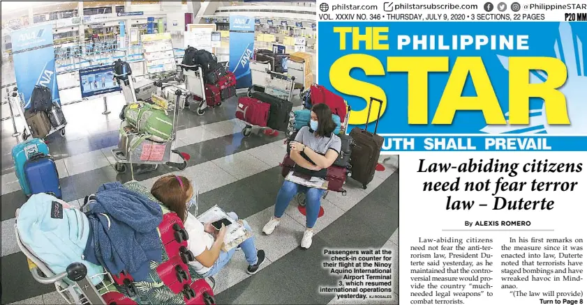  ?? KJ ROSALES ?? Passengers wait at the check-in counter for their flight at the Ninoy Aquino Internatio­nal Airport Terminal 3, which resumed internatio­nal operations yesterday.