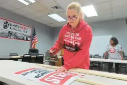  ?? WAYNE PARRY/AP ?? Ruth Ann Joyce, a bartender at the Harrah’s and Hard Rock casinos in Atlantic City, N.J., assembles “On Strike” signs at the Atlantic City headquarte­rs of Local 54 of the Unite Here union on Tuesday.