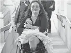  ??  ?? Sen. Tammy Duckworth, D- Ill., with her new daughter on Capitol Hill in 2018.
J. SCOTT APPLEWHITE/ AP