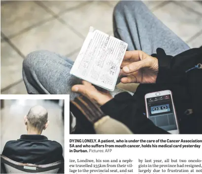 ?? Pictures: AFP ?? DYING LONELY. A patient, who is under the care of the Cancer Associatio­n SA and who suffers from mouth cancer, holds his medical card yesterday in Durban.
