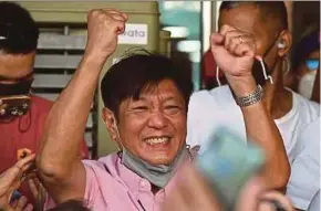  ?? AFP PIC ?? President-elect Ferdinand Marcos Jr celebratin­g with supporters at his campaign headquarte­rs in Manila on Wednesday.