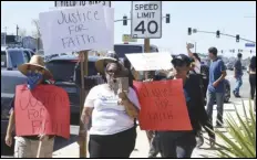  ?? ASSOCIATED PRESS ?? Priscilla Jeffers (center) participat­es in a Sunday protest in Victorvill­e in response to a video of what appears to be a San Bernardino County Sheriff’s deputy slamming a teen girl to the ground during a fight outside a high school football game.