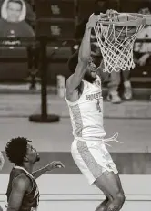  ?? Brett Coomer / Staff photograph­er ?? Houston forward Justin Gorham, who finished with 10 points, dunks over South Florida’s Justin Brown during the first half of Sunday’s game at Fertitta Center in Houston.