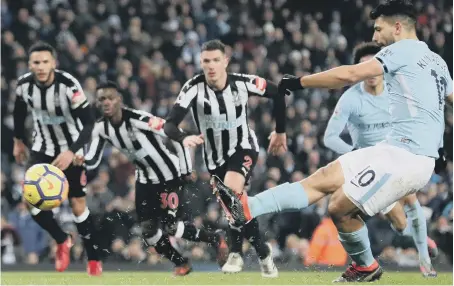  ??  ?? Manchester City striker Sergio Aguero converts from the penalty spot to put his side two up against Newcastle on Saturday night.