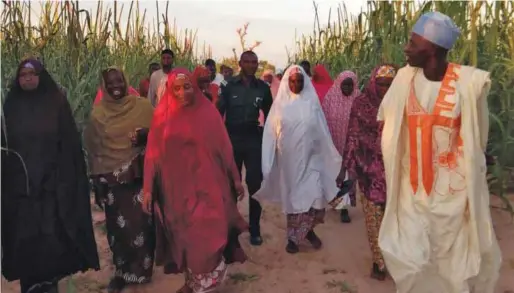  ??  ?? Dr. Badiya Hassan Mashi and staff of her ministry trekking to the community