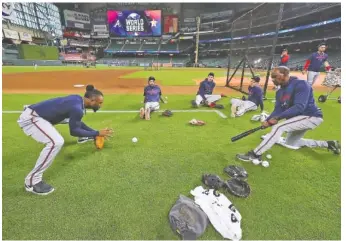  ?? CURTIS COMPTON/ATLANTA JOURNAL-CONSTITUTI­ON VIA AP ?? From left, Atlanta Braves second baseman Ozzie Albies, shortstop Dansby Swanson, third baseman Austin Riley and first baseman Freddie Freeman work with third base coach Ron Washington at Minute Maid Park during Monday’s practice before opening the World Series against the Houston Astros.