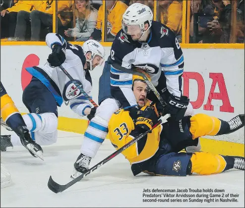  ?? GETTY IMAGES/PHOTO ?? Jets defenceman Jacob Trouba holds down Predators’ Viktor Arvidsson during Game 2 of their second-round series on Sunday night in Nashville.