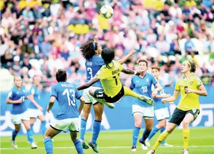  ?? GLADSTONE TAYLOR/MULTIMEDIA PHOTO EDITOR ?? Jamaica’s Khadija Shaw (airborne) attempts an acrobatic shot that was contested by Italy’s team captain Sara Gama (3) during their FIFA Women’s World Cup group stage match on June 14, 2019. Jamaica’s Havana Solaun (right) and Italy’s Elisa Bartoli (13) look on.