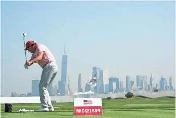  ?? KYLE TERADA, USA TODAY SPORTS STAN BADZ, PGA TOUR ?? Phil Mickelson practices at Liberty National Golf Club on Tuesday with a stunning view of the New York City skyline.