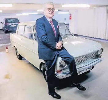  ??  ?? Franz Wielens vor einem Opel Kadett A aus dem Jahr 1962. Als der Wagen neu war, war er der große Konkurrent des VW Käfer, und Opel-Franz war damals 25 Jahre alt und gerade in die Branche eingestieg­en.