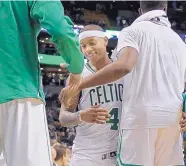  ?? ELISE AMENDOLA//ASSOCIATED PRESS ?? Boston’s Isaiah Thomas is greeted on the bench in the closing moments of the Celtics’ home victory over Miami on Friday night.