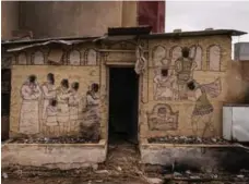  ??  ?? A biblical scene on a tomb that was defaced by Daesh militants in Bartella, a mainly Christian town located about 20 kilometres east of Mosul.