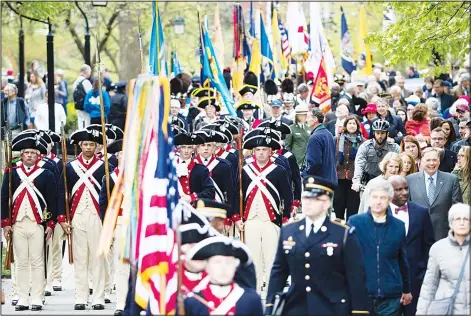  ?? (AP) ?? People move between opening ceremonies for the Museum of the American Revolution in Philadelph­ia on April 19.