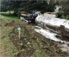  ?? PHOTO VIA MID-HUDSON NEWS NETWORK ?? A trucker was injured and lost a 30,000-pound load of milk Friday, Sept. 14, 2018, when his rig overturned and rolled twice off state Route 82 in Ancram, N.Y.
