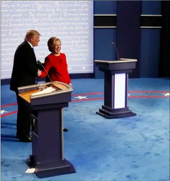  ??  ?? Republican presidenti­al nominee Donald Trump and Democratic presidenti­al nominee Hillary Clinton shake hands after the presidenti­al debate at Hofstra