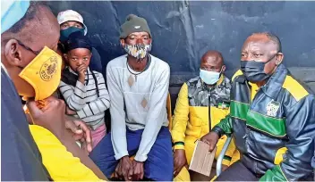  ?? /ANC ?? President Cyril Ramaphosa, with Jolidee Matongo sitting next to him, talk to residents of Nomzamo informal settlement in Soweto yesterday.