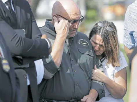  ?? Eric Gay/Associated Press ?? Pastor Frank Pomeroy and his wife, Sherri, join a news conference near the First Baptist Church of Sutherland Springs on Monday in Sutherland Springs, Texas. The Pomeroys’ daugher, Annabelle, 14, was killed in the shooting that took place in the church on Sunday.