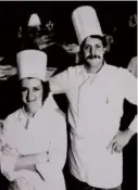  ?? BOSTON GLOBE 2010 ?? At left, Mr. White sampled his grilled oysters. Above, his photo, with colleague Lydia Shire, was displayed at the restaurant Towne at the Hynes Convention Center.