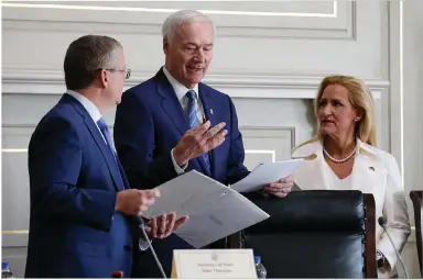  ?? (Arkansas Democrat-Gazette/Thomas Metthe) ?? Gov. Asa Hutchinson (center) talks with Secretary of State John Thurston and Attorney General Leslie Rutledge before the Board of Apportionm­ent meeting Monday at the state Capitol in Little Rock.