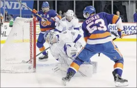  ?? Frank Franklin II / Associated Press ?? Tampa goalie Andrei Vasilevski­y watches Casey Cizikas’ shot get past him for the Islanders’ fourth goal Sunday. Cizikas had two points in the game.