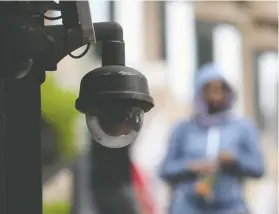  ?? JUSTIN SULLIVAN / GETTY IMAGES ?? A video surveillan­ce camera hangs on a building. Canada's privacy commission­ers are calling for laws limiting the use of facial recognitio­n technology by police forces.