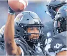  ?? DAVID ZALUBOWSKI/AP ?? Air Force wide receiver Marcus Bennett holds the ball aloft after catching a touchdown pass in the second quarter during the Falcons’ win over Colorado State.