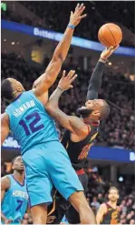  ??  ?? JOSHUA Gunter/cleveland.com Cavaliers forward Lebron James (R) puts up a tough shot against the long reach of Hornets center Dwight Howard in the first half of an NBA fixture at Cleveland’s Quicken Loans Arena on November 24, 2017.