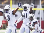 ?? James Black / Icon Sportswire via Getty Images ?? UConn’s Diamond Harrell (3) and D.J. Morgan (41) signal a recovered fumble as Omar Fortt (27) comes up with the ball during a 2019 game at Indiana.