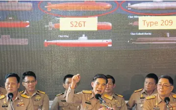  ?? WICHAN CHAROENKIA­TPAKUL ?? Navy chief of staff Adm Luechai Ruddit, middle, chairman of the navy’s submarine procuremen­t management panel, addresses a press conference yesterday to clear up lingering questions raised over the controvers­ial purchase.