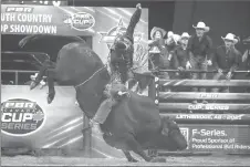  ??  ?? Zane Lambert from Ponoka holds on tight for one of his PBR winning rides in Lethbridge.