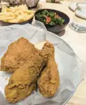  ?? ?? Pictured is a 3-piece dark meat, mac and cheese and cooked greens (kale) at the Neat Bird restaurant in Chesapeake, Virginia.