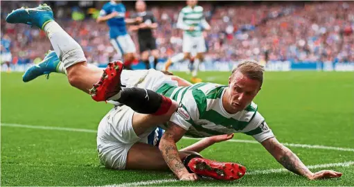  ??  ?? Leigh Griffiths is fouled by Rangers’ Ross McCrorie in the Scottish Premiershi­p match yesterday. Celtic won 2- 0. — Reuters No gentleman’s game: Celtic’s