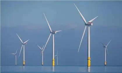  ?? Photograph: Rob Arnold/Alamy ?? Wind turbines off the coast of Barrow-in-Furness.