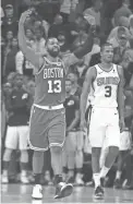  ??  ?? Marcus Morris (13) celebrates after the Celtics beat the Suns in overtime at Talking Stick Resort Arena on Thursday night.