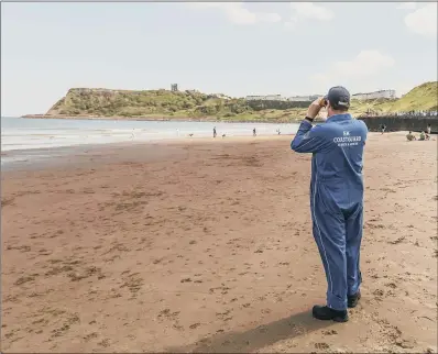  ?? PICTURE: DANNY LAWSON/PA ?? ON THE LOOKOUT: An HM Coastguard on Scarboroug­h beach, as people head to the seaside with lockdown measures eased.