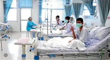  ?? AP ?? In this image made from video released by the Thailand Government Spokesman Bureau, three of the 12 boys are seen recovering in their hospital beds after being rescued along with their coach from a flooded cave in Mae Sai.