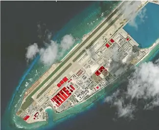  ?? CSIS/AP ?? This satellite photo provided by the CSIS Asia Maritime Transparen­cy Initiative shows Chinese constructi­on work that has taken place this year, marked in red, on Fiery Cross Reef in the Spratly chain. Large undergroun­d tunnels identified earlier this...