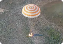  ?? — AFP ?? The Soyuz MS-03 capsule carrying the Internatio­nal Space Station crew of Oleg Novitskiy of Russia and Thomas Pesquet of France lands in a remote area outside the town of Dzhezkazga­n (Zhezkazgan), Kazakhstan on Friday.