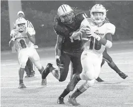  ?? CARL JUSTE/MIAMI HERALD ?? Chaminade quarterbac­k Daelen Menard, right, and his teammates were thumped by Miami Central last week. They face Miramar tonight as Patriots coach A.J. Scott is making his full-time coaching debut.