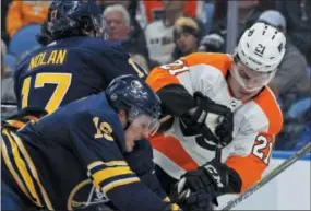  ?? THE ASSOCIATED PRESS FILE ?? Sabres defenseman Jake McCabe, left, mixes it up with the Flyers’ Scott Laughton during a game last Dec. 22. Laughton could throw his body around a bit more and hopefully use more of his scoring skills if the Flyers put him on left wing next season.