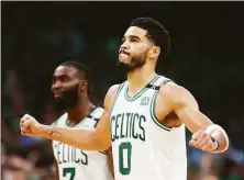  ?? Adam Glanzman / Getty Images ?? The Celtics’ Jayson Tatum (0) and Jaylen Brown react during the fourth quarter on Sunday.