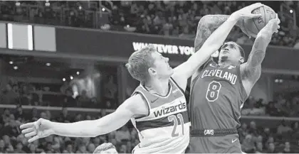  ?? NICK WASS/AP ?? Cavaliers guard Jordan Clarkson finds it’s difficult to shoot as he is defended by Wizards forward Moritz Wagner on Nov. 8.