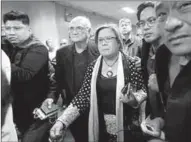  ??  ?? Sen. Leila de Lima is escorted by the Senate’s security personnel after a Regional Trial Court (RTC) ordered her arrest. (Photo: reuters)