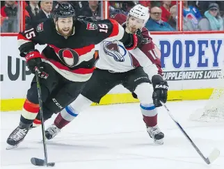  ?? ERROL MCGIHON ?? Senators centre Zack Smith fights off the check of Colorado’s Blake Comeau in their game Thursday night at Canadian Tire Centre. Colorado won 4-3.