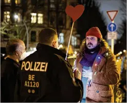  ?? PHOTOS BY MARKUS SCHREIBER/AP ?? Police stop an activist who refused to wear a mask as he tries to disrupt a counterpro­test on Jan. 24 in Berlin. More Germans are speaking out against anti-vaccine protests and far-right extremists.