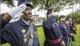  ?? MICHAEL BRYANT / THE PHILADELPH­IA INQUIRER ?? Albert El (left), representi­ng the 3rd Regiment of Pennsylvan­ia, salutes the fallen Union soldiers laid to rest during the annual Decoration Day service Sunday at the Laurel Hill Cemetery in Philadelph­ia.